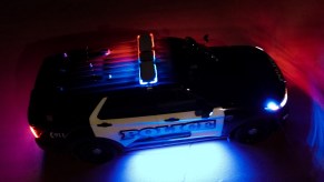 A police SUV at night with lights on