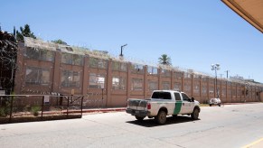 a Border Patrol truck by a wall