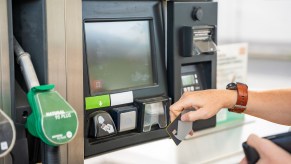 A person paying for gas with a credit card