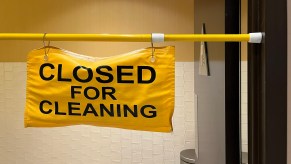 A sign that says the bathroom is closed for cleaning