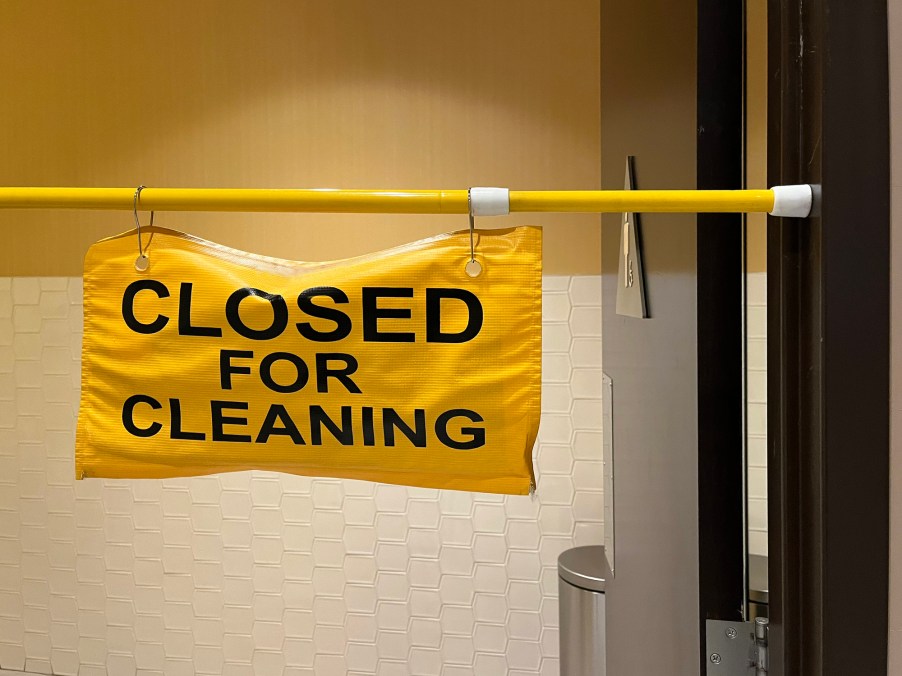 A sign that says the bathroom is closed for cleaning