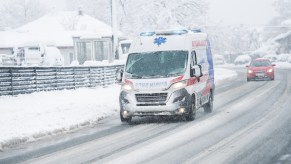 An ambulance on a snow covered road