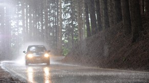 A car on the road as it rains during the day