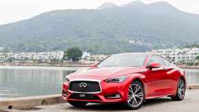 A 2017 Infiniti Q60 in front of a scenic lake