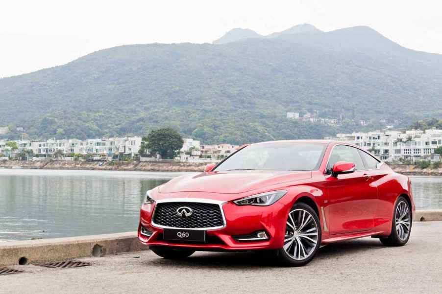 A 2017 Infiniti Q60 in front of a scenic lake