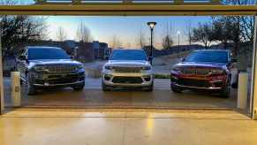 Jeep SUVs parked at the entrance of a large garage door