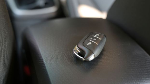 A vehicle's key fob sitting on the center console