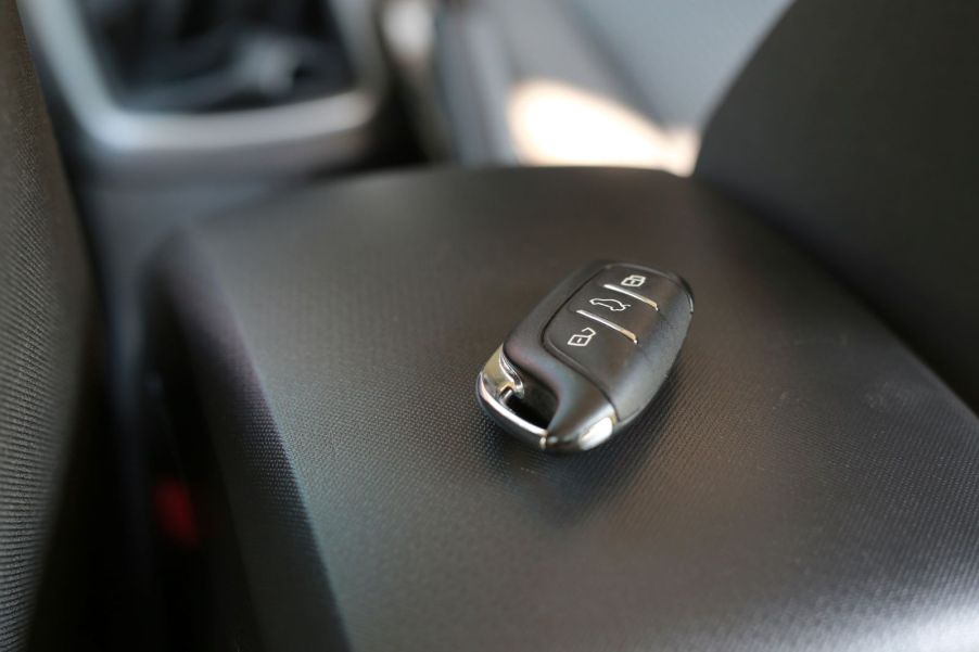 A vehicle's key fob sitting on the center console