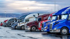 Semi-trucks at a dealership lined up for sale