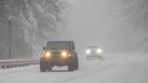 A Jeep Wrangler driving in the snow