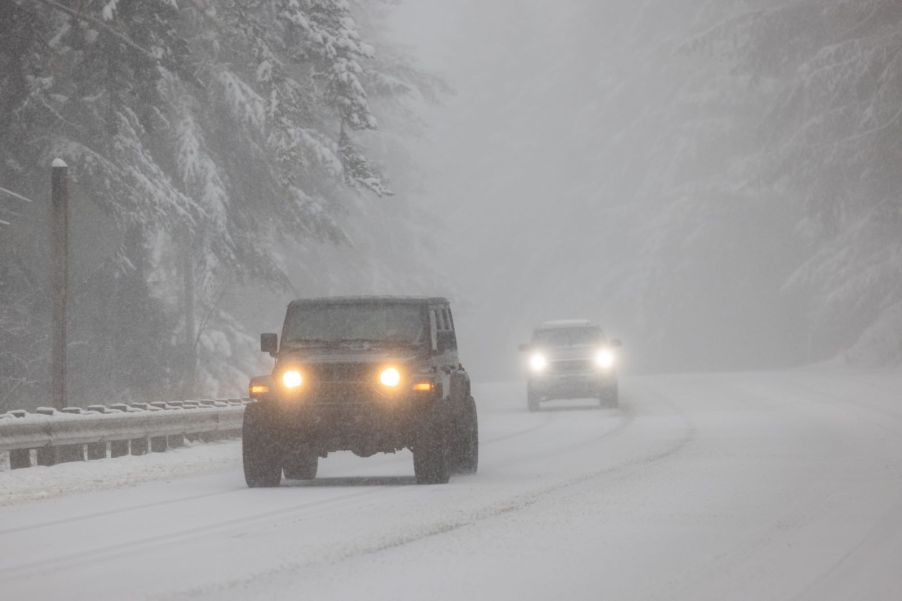 A Jeep Wrangler driving in the snow