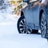 A car parked in the snow with snow tires