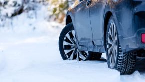 A car parked in the snow with snow tires