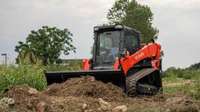 A Kubota Track Loader pushes dirt on a job site.