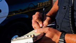 A police officer writing a driver a ticket