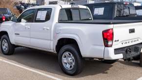 A white Toyota Tacoma in a dealership lot