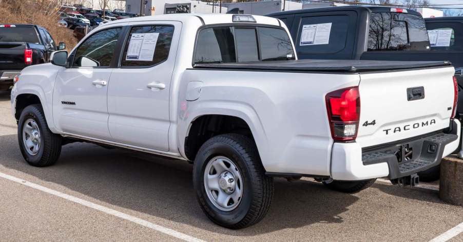 A white Toyota Tacoma in a dealership lot