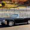 A black 1962 Lincoln Continental convertible parked in left angle profile view