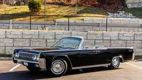 A black 1962 Lincoln Continental convertible parked in left angle profile view