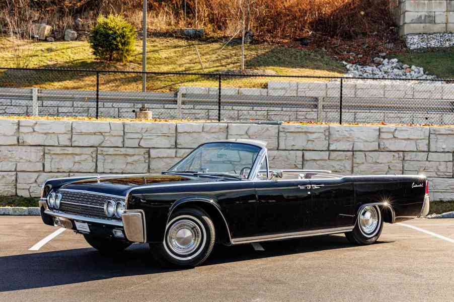 A black 1962 Lincoln Continental convertible parked in left angle profile view