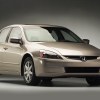 A gold 2003 Honda Accord press kit photo from the Honda Newsroom car parked in right front angle view