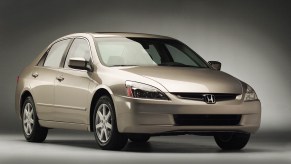 A gold 2003 Honda Accord press kit photo from the Honda Newsroom car parked in right front angle view