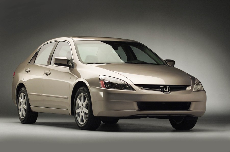 A gold 2003 Honda Accord press kit photo from the Honda Newsroom car parked in right front angle view