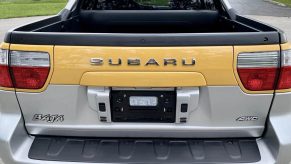 A yellow 2003 Subaru Baja truck's bed in close rear view