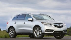 A silver 2016 Acura MDX parked in right front angle view