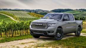 Ramcharger hybrid half-ton pickup truck with 14,000-pound tow rating parked on a farm.