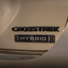 Tan Subaru Crosstrek with a Hybrid badge.