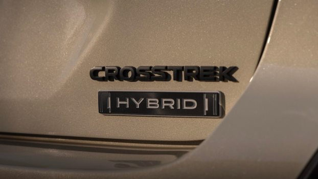 Tan Subaru Crosstrek with a Hybrid badge.