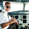 An airline pilot smiles after talking to air traffic control.