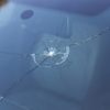 A broken windshield following a dangerous road rage event.