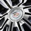 The Cadillac logo in the center of an electric concept sedan wheel.