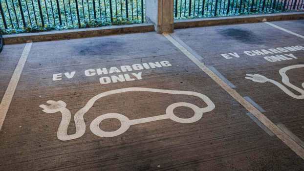 A row of EV charging spots in a garage.