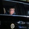 President Donald Trump looks out the window of his Cadillac Limousine, "The Beast"