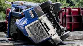 Large semi truck rolled over in the road