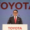 Akio Toyoda behind a Toyota podium during a press conference