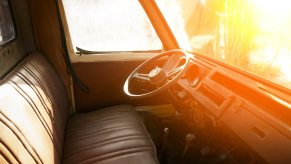 Classic pickup truck with a wide bench seat, the sun setting outside the windshield