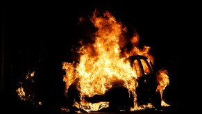 A car on fire at night