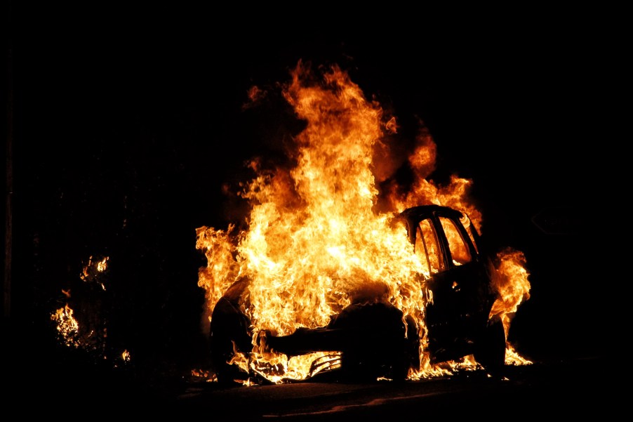 A car on fire at night