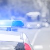 Cop car's roof with lights on in close rear view