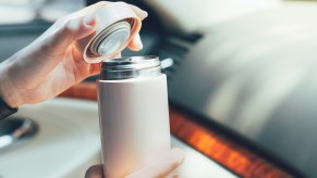 driving with metal water bottle in close view