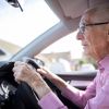 An elderly man driving