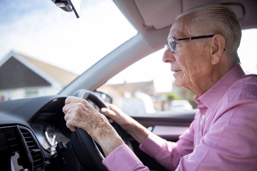 An elderly man driving