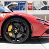 A red Ferrari SF90 in close right front profile view