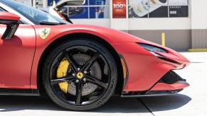 A red Ferrari SF90 in close right front profile view