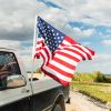 Ford F-150 pickup truck with an American flag in the bed.