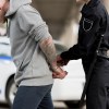 A man being arrested by a police officer